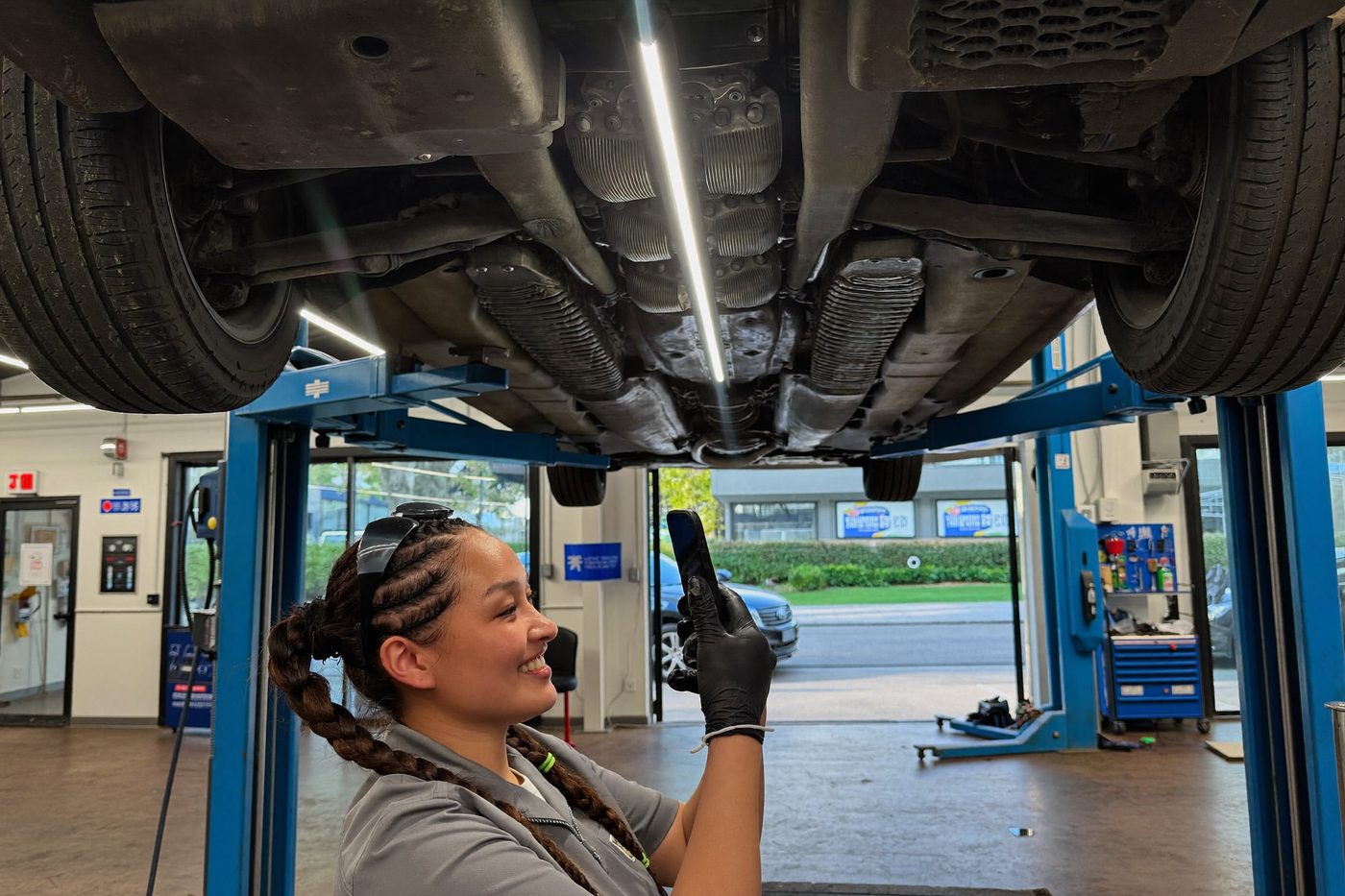 Technician working under a lifted vehicle
